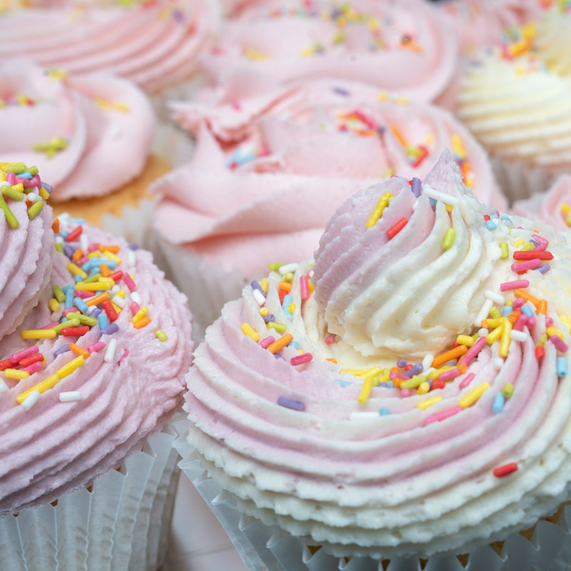 Cupcakes with swirls of pink frosting and sprinkles